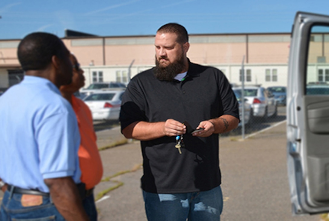 DLA Installation Support at Richmond employee Derrik Griner issues Defense Supply Center Richmond employees a government vehicle Oct. 13, 2015 and gives guidance on vehicle technology, safety and use.