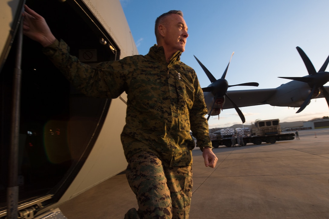 U.S. Marine Corps Gen. Joseph F. Dunford Jr., chairman of the Joint Chiefs of Staff, departs a C-130 while visiting Airmen stationed on Ramstein Air Base, Germany, Dec. 9, 2015. Dunford  and entertainers with the 2015 USO Holiday Tour visited service members deployed to various locations overseas. DoD photo by D. Myles Cullen