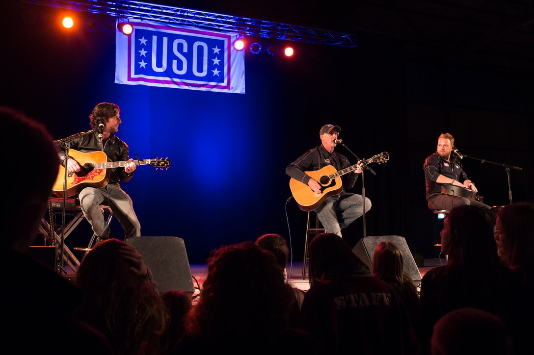 Song writers Kyle Jacobs, Brett James and Billy Montana perform in a USO show for military members and their families at Ramstein Air Base, Germany, Dec. 9, 2015. Entertainers with the 2015 USO Holiday Tour traveled to various locations to visit service members deployed overseas. DoD photo by D. Myles Cullen