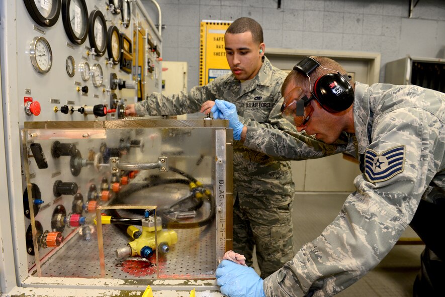 Tech. Sgt. Theodore Kolffvanoosterwyk, 2nd Maintenance Operation Squadron hydraulic systems craftsman, and Senior Airman Jeffrey Valentin, 2nd Maintenance Squadron hydraulic systems journeyman, test the pounds per square inch of a hydraulic valve at Barksdale Air Force Base, La., Dec. 4, 2015. Hydraulic valves must be able to handle immense pressure on a daily basis. (U.S. Air Force photo/Airman 1st Class Luke Hill)