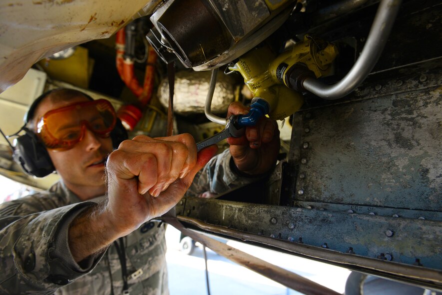 Tech. Sgt. Theodore Kolffvanoosterwyk, 2nd Maintenance Operation Squadron hydraulic systems craftsman, repairs landing gear during a hydraulic test on a B-52 Stratofortress at Barksdale Air Force Base, La., Dec. 8, 2015. The landing gear was inspected to ensure it kept working at peak performance. (U.S. Air Force photo/Airman 1st Class Luke Hill)