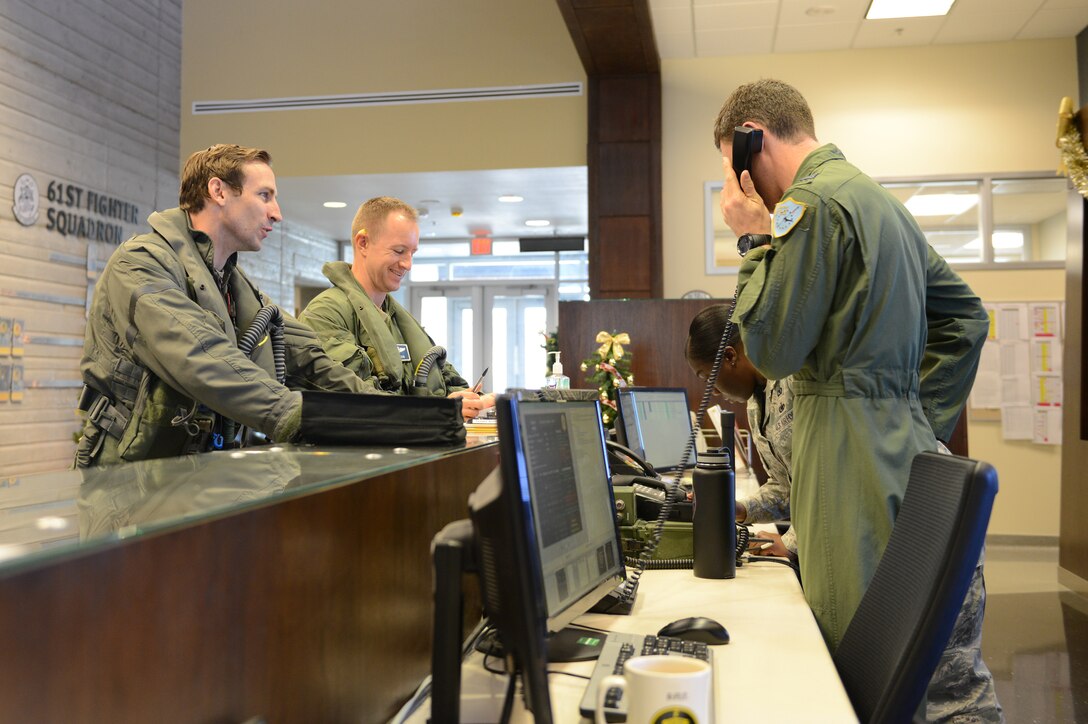 Lt. Col. Eric Puels, left, 944th Operations Group Detachment 2 director of operations, gets his step brief prior to flight at Luke Air Force Base, Ariz., Dec. 10, 2015. Puels flew the F-35 Lightning II marking the 3000th sortie for Luke F-35s. (U.S. Air Force photo by Senior Airman James Hensley)
