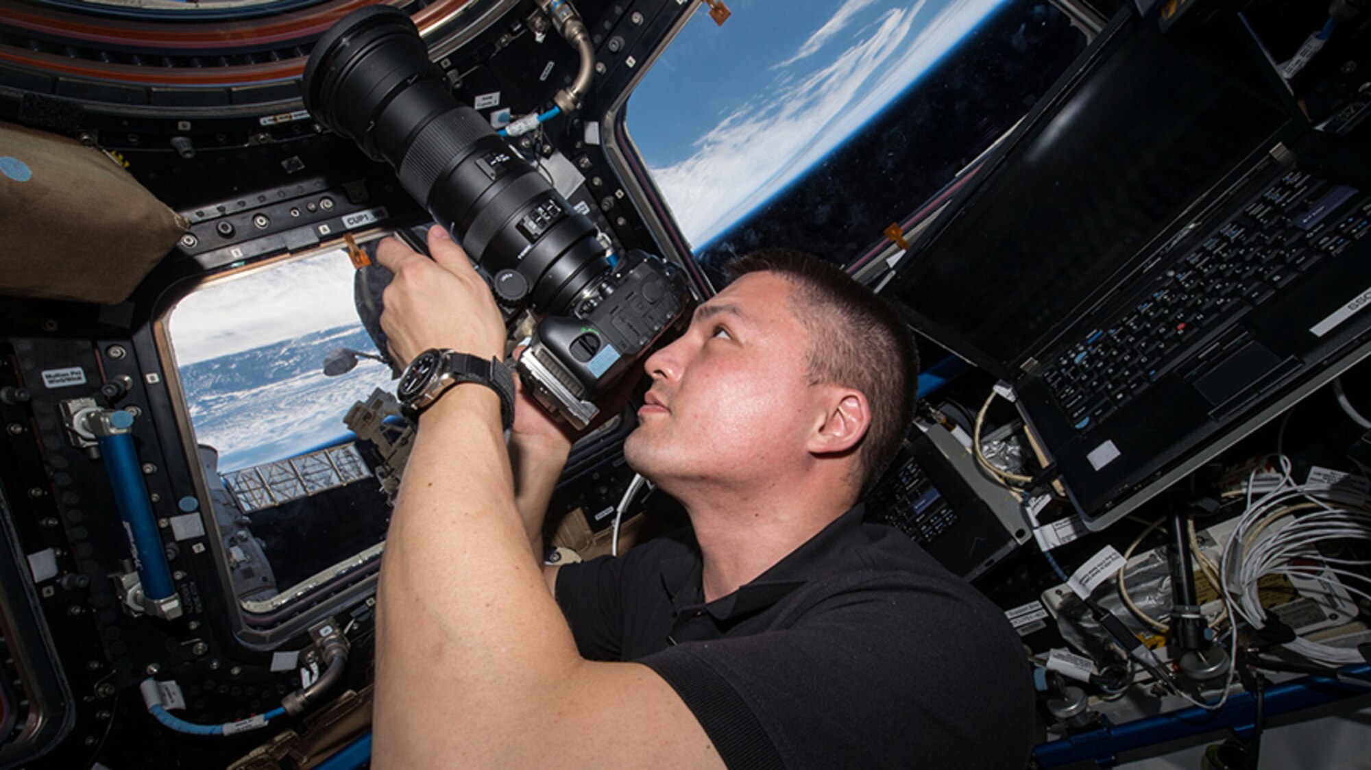 NASA flight engineer Kjell Lindgren, a Class of '95 Academy graduate, uses a camera on the International Space Station, Dec. 15, 2015. On Dec. 9, 2015, he successfully docked a spacecraft containing research supplies to the station. (NASA photo)