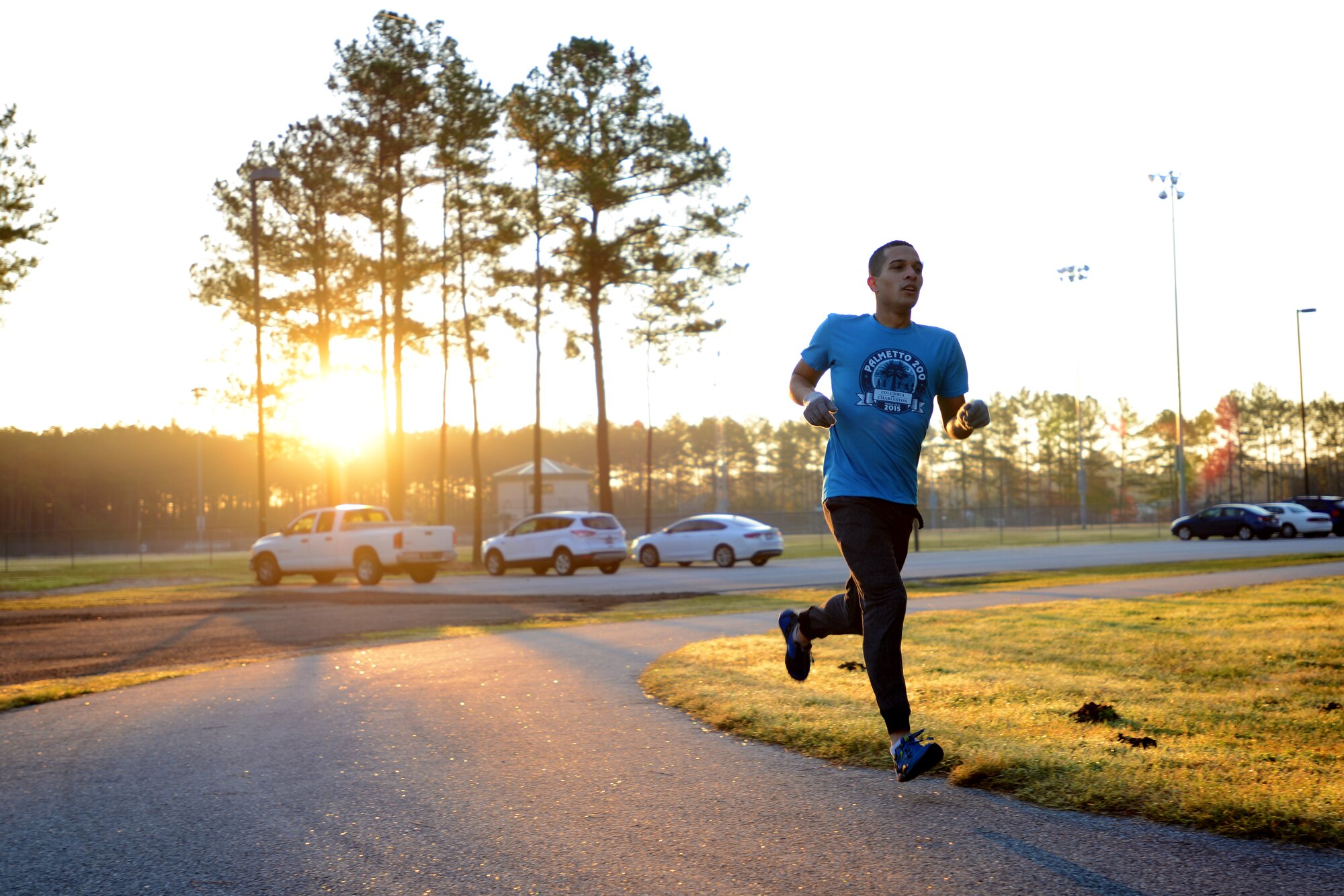 A Team Shaw member runs along the track near the sports complex during a Jingle Bell 1.5 mile run at Shaw Air Force Base, S.C., Dec. 10, 2015. The 20th Force Support Squadron hosted the run, with prizes for the best dressed and first and second place finishers. (U.S. Air Force photo by Airman 1st Class Kelsey Tucker)