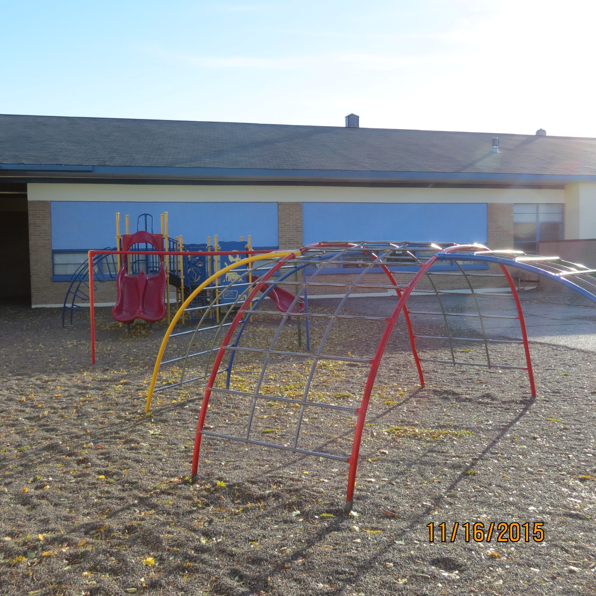 Freshly painted playground equipment stands ready for children at East Elementary School in Mountain Home, Idaho, Aug. 7, 2015. School Advisory Committee members and other volunteers painted the worn-down playground and the bright, primary colors were meant to increase morale and school pride for students. (Courtesy photo by Master Sgt. Ann Mitchell)