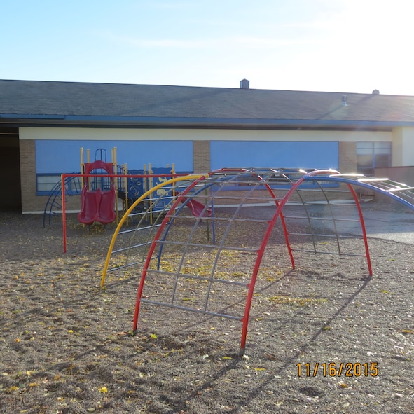 Freshly painted playground equipment stands ready for children at East Elementary School in Mountain Home, Idaho, Aug. 7, 2015. School Advisory Committee members and other volunteers painted the worn-down playground and the bright, primary colors were meant to increase morale and school pride for students. (Courtesy photo by Master Sgt. Ann Mitchell)