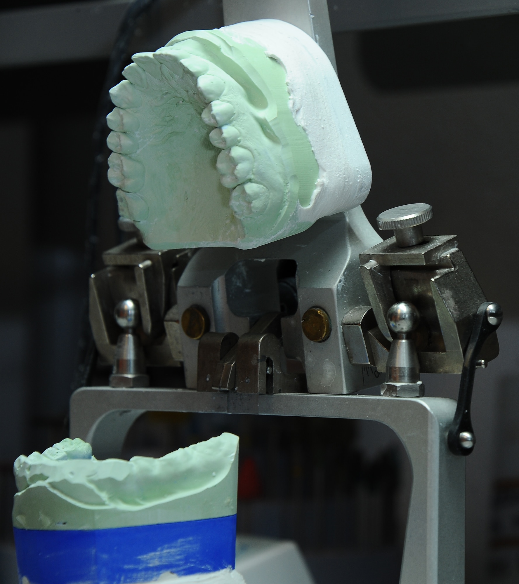 An articulator holds a dental impression cast in place inside the 355th Dental Squadron laboratory at Davis-Monthan Air Force Base, Ariz., Nov. 3, 2015. 355th DS laboratory technicians fabricate and repair mouth guards, crowns and retainers. (U.S. Air Force photo by Airman 1st Class Mya M. Crosby/Released)