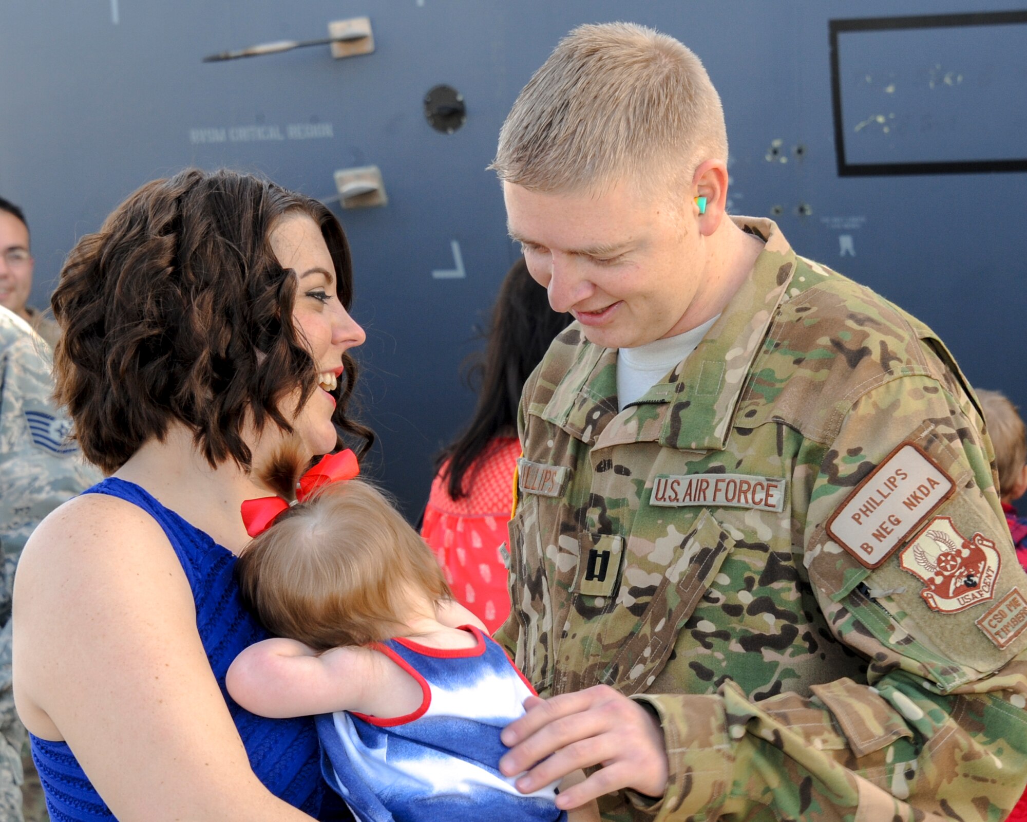 U.S. Air Force Capt. David Phillips, 79th Rescue Squadron combat systems officer, is greeted by his wife, Leslie, and his daughter on the flightline at Davis-Monthan Air Force Base, Ariz., Dec. 10, 2015.  Members of the 79th RQS and 923rd Aircraft Maintenance Squadron returned from a 3-month deployment to Southwest Asia in support of Operation Inherent Resolve. (U.S. Air Force photo by Senior Airman Chris Massey/Released)