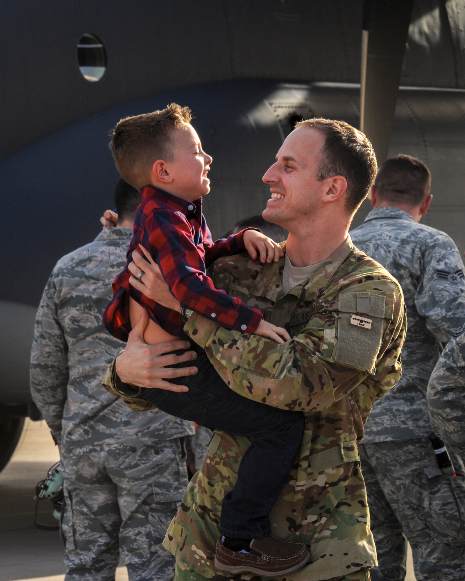 U.S. Air Force Capt. David Thomson, 79th Rescue Squadron combat systems officer, walks off the flightline with his wife, Kayla, and their three children at Davis-Monthan Air Force Base, Ariz., Dec. 10, 2015.  Members of the 79th RQS and 923rd Aircraft Maintenance Squadron returned from a 3-month deployment to Southwest Asia in support of Operation Inherent Resolve. (U.S. Air Force photo by Senior Airman Chris Massey/Released)