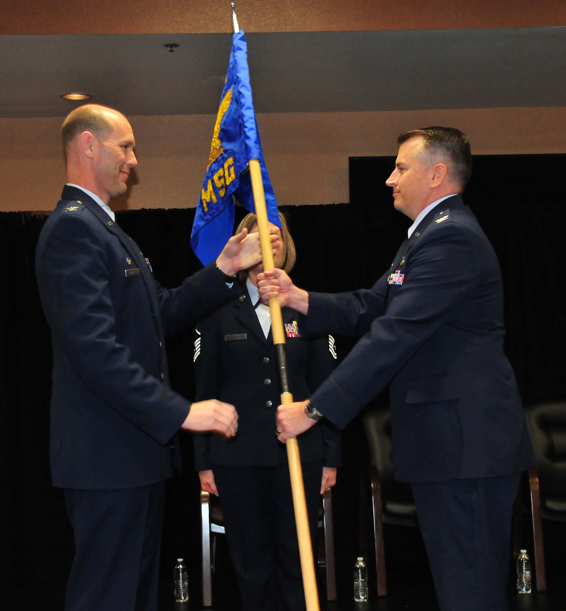 Col. David J. Ciesielski accepts the 161st Mission Support Group guidon from Col. Troy T. Daniels, commander 161st Air Refueling Wing during the 161st MSG change of command at Phoenix Sky Harbor Air National Guard Base, Dec. 6, 2015. Col. Ciesielski succeeds Col. Kyle T. Kobashigawa as commander of the 161st MSG. (U.S. Air National Guard photo by Master Sgt. Kelly Deitloff)