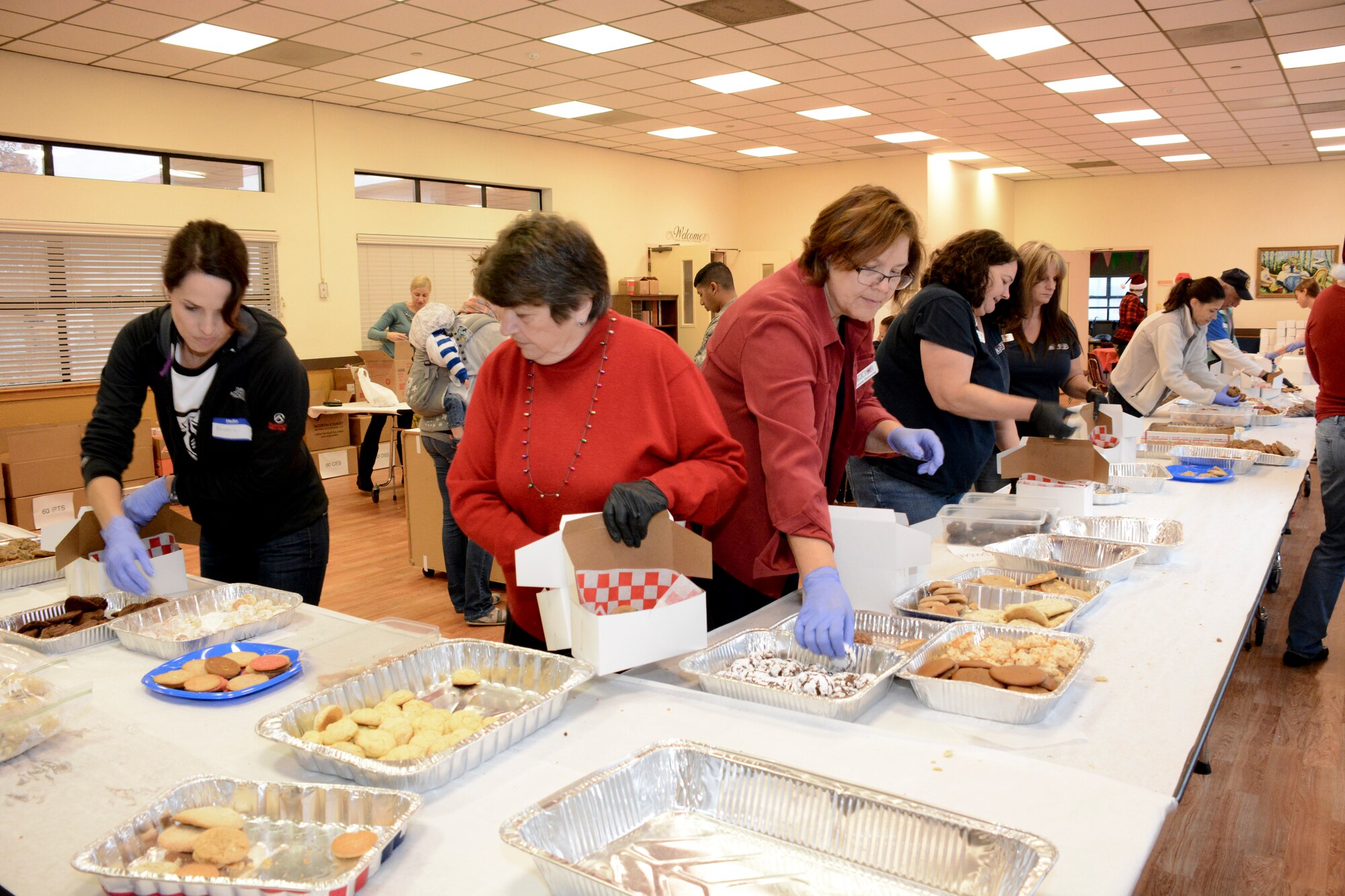 A cookie boxing assembly line was manned by volunteers Dec. 9 at the First Street Chapel at Travis Air Force Base, California. Boxes were made, cookies were hand selected for each box, the boxes were wrapped and included a donated card from military supporters. (U.S. Air Force photos by Airman 1st Class Amber Carter)
