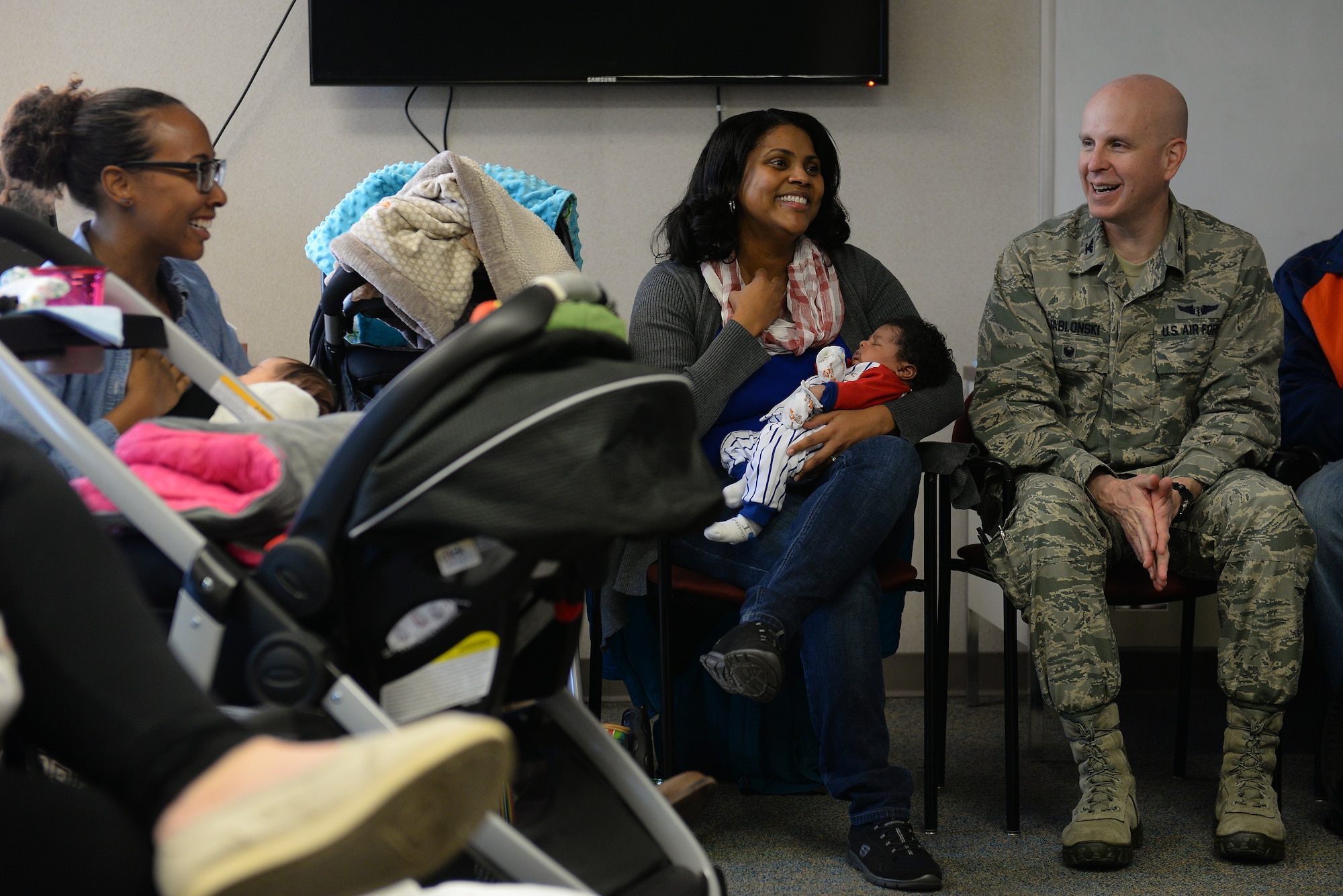 Col. James Jablonski, 375th Medical Group family residency program master academician, talks with new moms during a Centering Pregnancy support group reunion, Dec. 1, 2015, Belleville, Illinois. Jablonski is one of the family medicine physicians who facilitate the support group, another of which will be starting in January. (U.S. Air Force photo by Airman 1st Class Erica Holbert-Siebert)