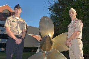 (From left to right) Petty Officer 3rd Class Rylee Schaefer, Navy Nuclear Power Training Command electronics technician graduate, stands with MCPO Paul Karrow, NNPTC Indoctrination Coordinator, outside the NNPTC school at Joint Base Charleston – Naval Weapons Station, S.C., on Dec. 7, 2015. The NNPTC moved from the Naval Training Center in Orlando, FL. to the Naval Weapons Station in 1998. (U.S. Air Force photo/Airman 1st Class Thomas T. Charlton)