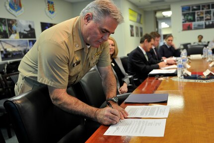 Capt. Timothy Sparks, Joint Base Charleston deputy commander, approves the first Air Force Partnership Program (P4) initiative during the way ahead meeting held at the 629th Air Base Wing conference room, Joint Base Charleston - Air Base, S.C., Dec. 4, 2015. The P4 program pairs up military and civilian leaders to brainstorm ways of cross-utilizing resources through partnerships. (U.S. Air Force approves the first completed initiative photo/Tech. Sgt. Renae Pittman)