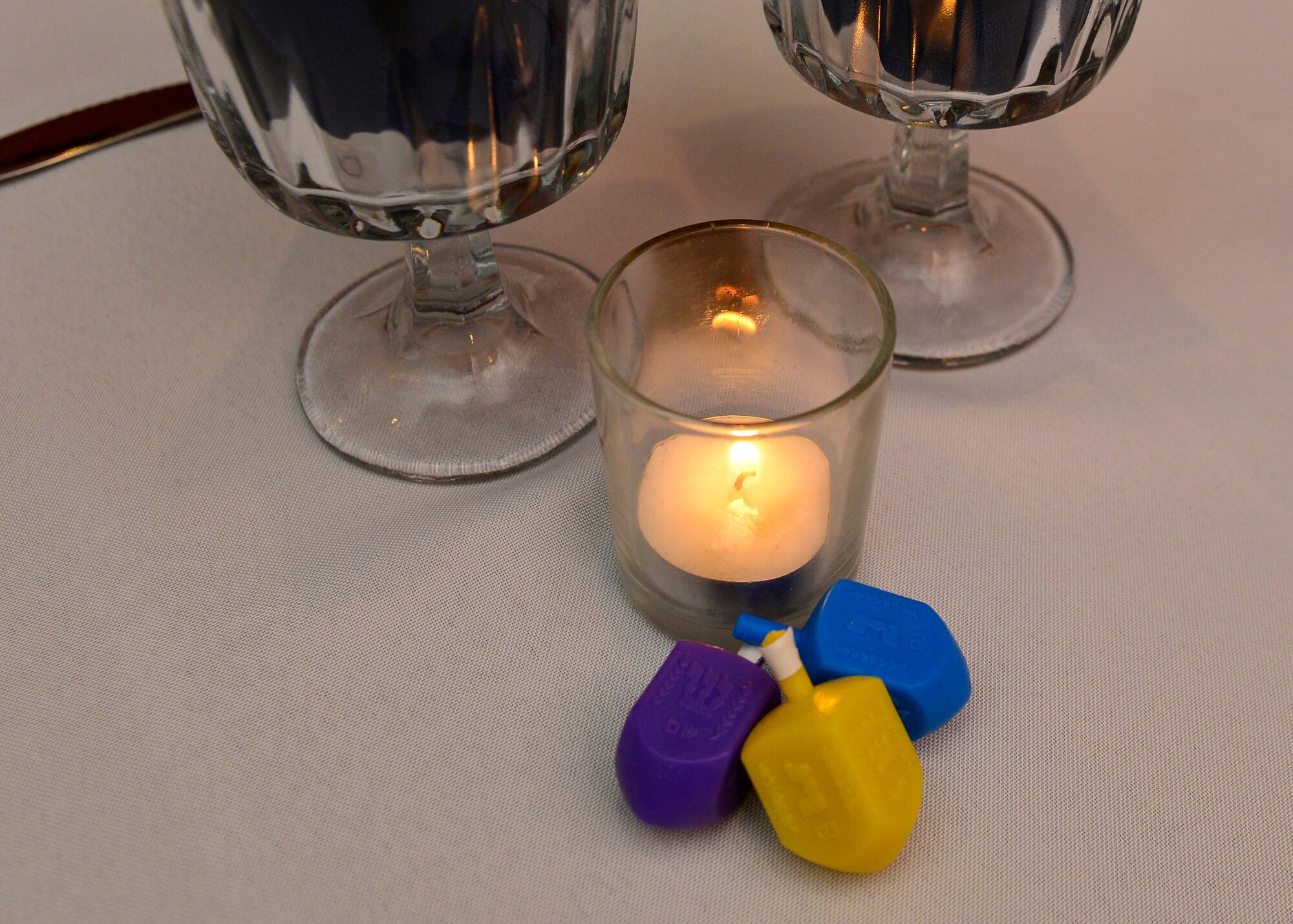 Dradles decorate a table during an inter-faith Hanukkah celebration, Dec. 8, 2015, at Aviano Air Base, Italy. The chapel hosted the dinner to recognize freedom of religion. (U.S. Air Force photo by Airman 1st Class Cary Smith/Released)
