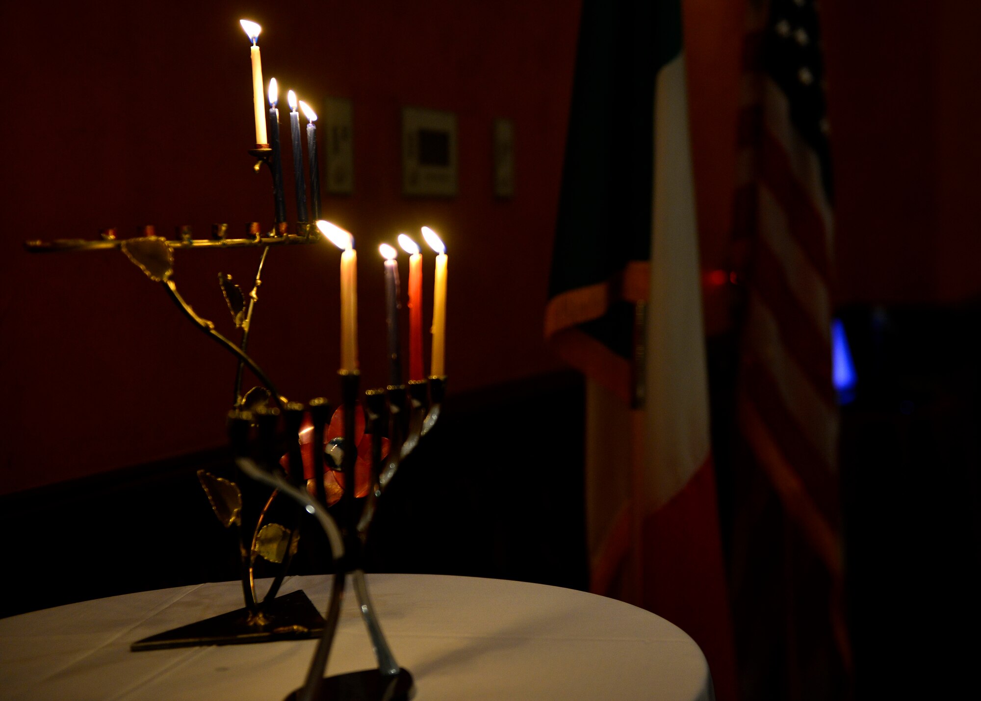 A lit Menorah is displayed during an inter-faith Hanukkah celebration, Dec. 8, 2015, at Aviano Air Base, Italy. The Menorah was lit during the celebration, which also included dinner, prayer and scripture readings. (U.S. Air Force photo by Airman 1st Class Cary Smith/Released)