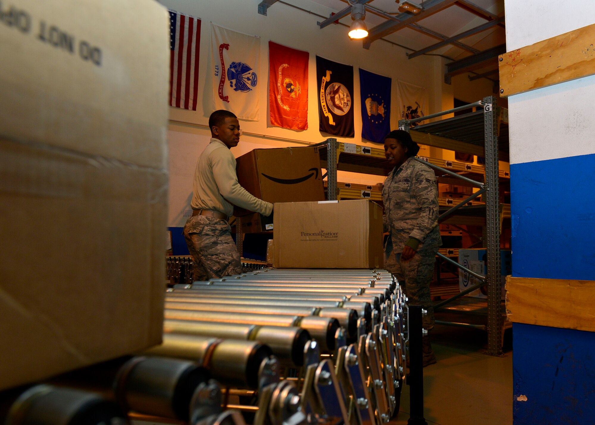 (From left) U.S. Air Force Airmen 1st Class TeDera Graves and Alexis George, 31st Communications Squadron postal clerks, sort packages from the morning’s delivery, Dec. 9, 2015, at Aviano Air Base, Italy. The post office receives an average 1,500 to 2,000 packages daily during the holiday season. (U.S. Air Force photo by Airmen 1st Class Cary Smith/Released)