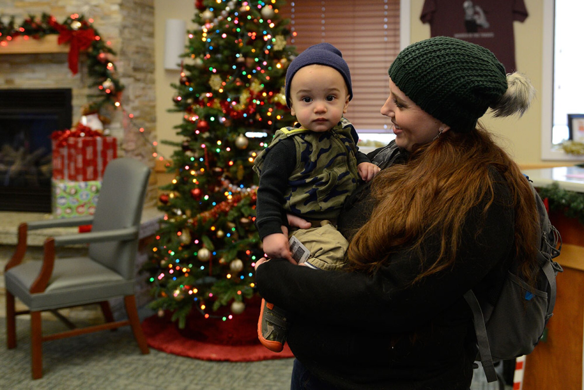 Sara Foster, laughs with son, Luke Foster,1, during Operation Warmheart’s holiday toy drive, at Joint Base Elmendorf-Richardson, Dec. 4, 2015. The Operation Homefront holiday toy drive is a program used to distribute toys and gift cards to junior enlisted military families. Luke is the son of Tech. Sgt. Jeremy Foster, with the 732nd Air Mobility Squadron. (U.S. Air Force photo by Airman Valerie Monroy)
