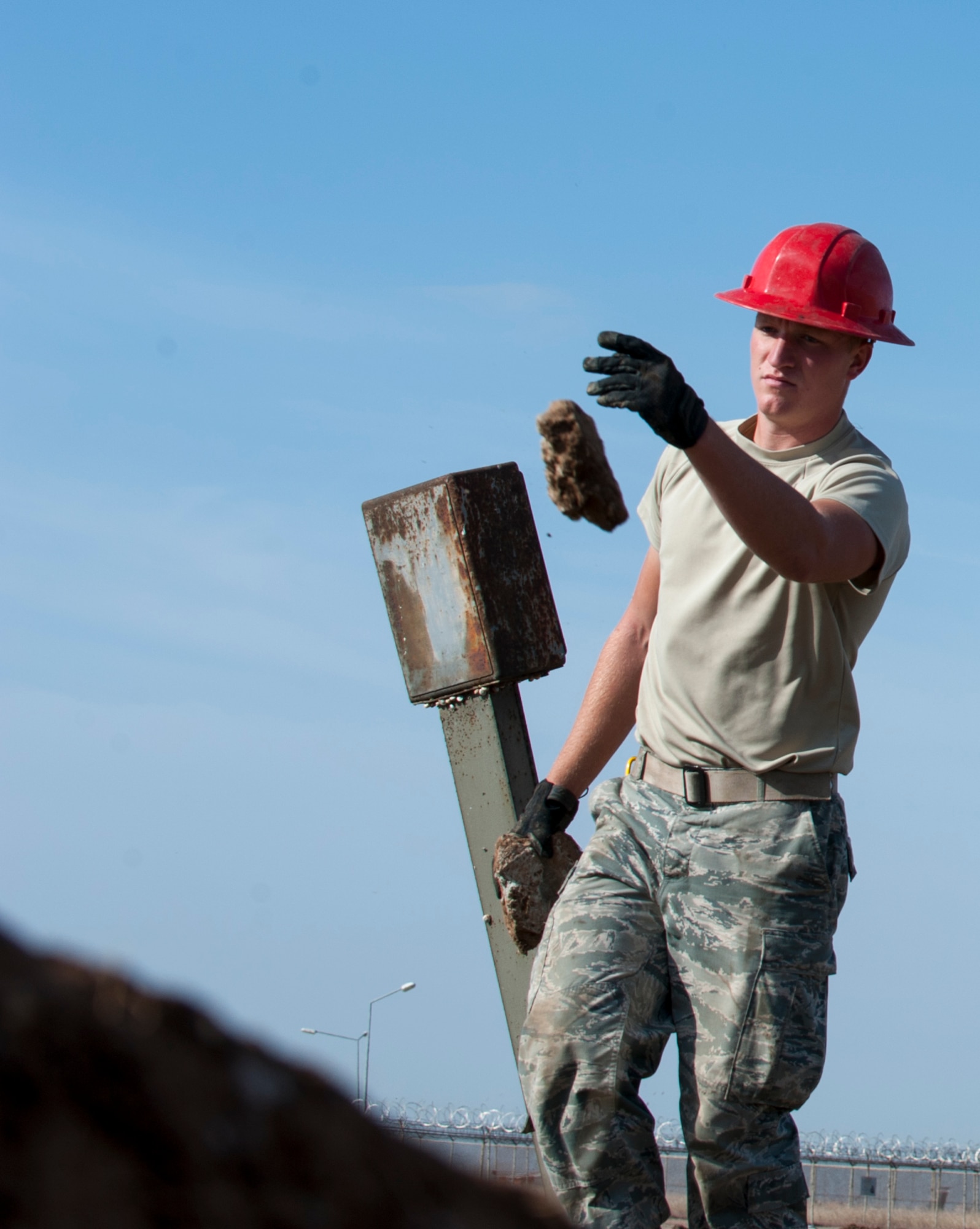 Airman 1st Class Zachary Keep, 39th Communications Squadron cable and antenna systems technician, removes rocks, unearthed during trenching, from the work site Nov. 18, 2015, at Incirlik Air Base, Turkey. The CS works to establish and maintain new and old infrastructure to ensure Incirlik, and Operation Inherent Resolve, missions are accomplished. (U.S. Air Force photo by Staff Sgt. Jack Sanders/Released) 
