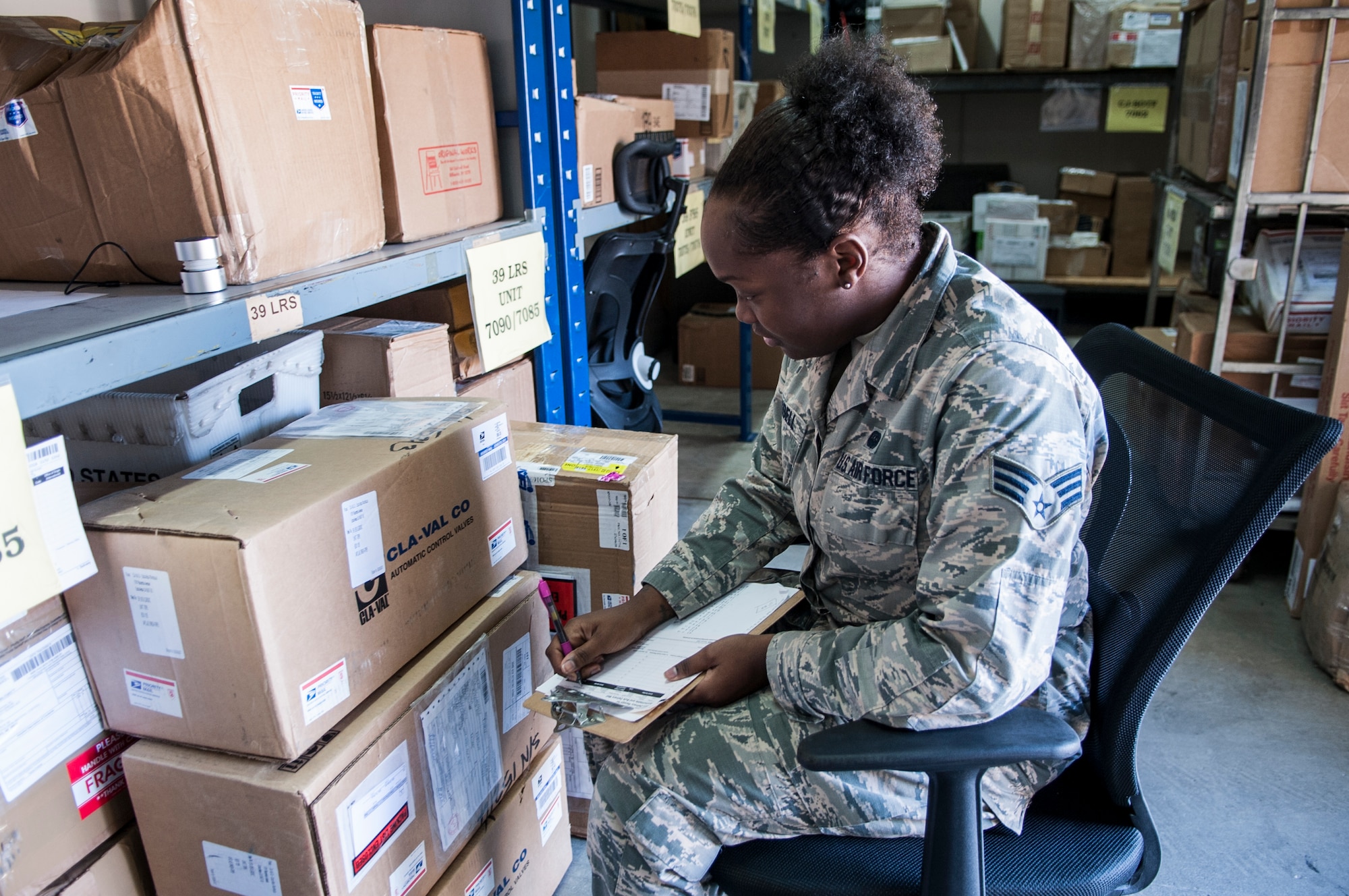 Senior Airman Shanna Russell, 39th Communications Squadron mail clerk, annotates tracking information from received secure mail Nov. 17, 2015, at Incirlik Air Base, Turkey. Airmen from the 39th CS and mail clerk volunteers at the post office are responsible for managing and storing all secure mail received here. The mail clerk volunteer program in place at Incirlik AB helps the mail clerks during the increase of postage during increased operations and the holidays.(U.S. Air Force photo by Staff Sgt. Jack Sanders/Released)