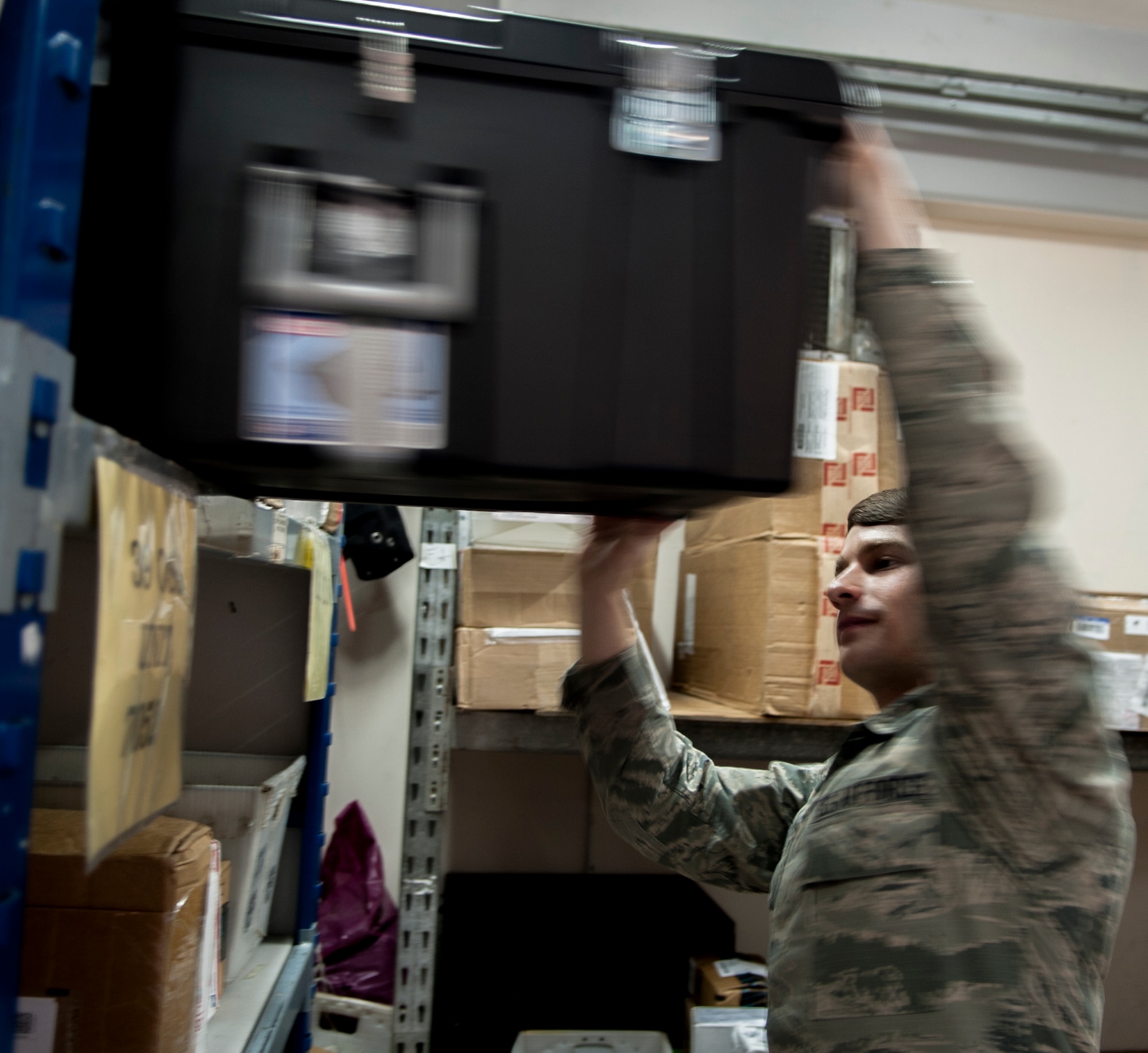 Airman 1st Class Clint Vetzel, 39th Communication Squadron mail clerk, places a package on a storage shelf Nov. 17, 2015, at Incirlik Air Base, Turkey. Vetzel is deployed to the 39th CS from RAF Alconbury, U.K .  The 39th CS has deployed members integrated into every section to assist with the increased operations tempo here. (U.S. Air Force photo by/Staff Sgt. Jack Sanders/Released)