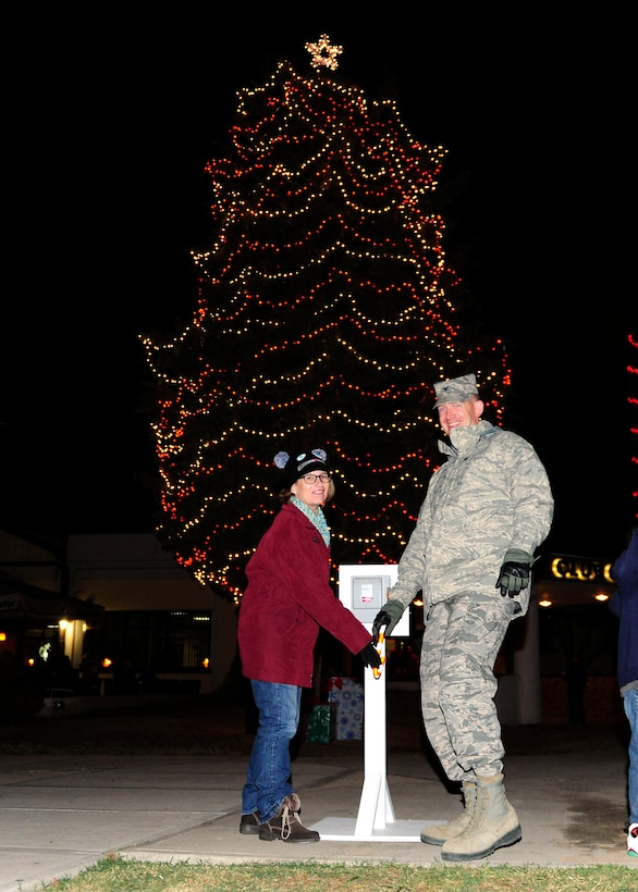 Col. John Walker, 39th Air Base Wing commander, and his wife Ms. Walker, flip the switch to light officially light the tree during the 2015 Incirlik Holiday Tree Lighting ceremony Dec. 1, 2015, at Incirlik Air Base, Turkey. Events of the tree lighting included a speech from Col. John Walker, 39th Air Base Wing commander, a visit from Santa Claus and the singing of holiday carols. (U.S. Air Force photos by Senior Airman Krystal Ardrey/Released)