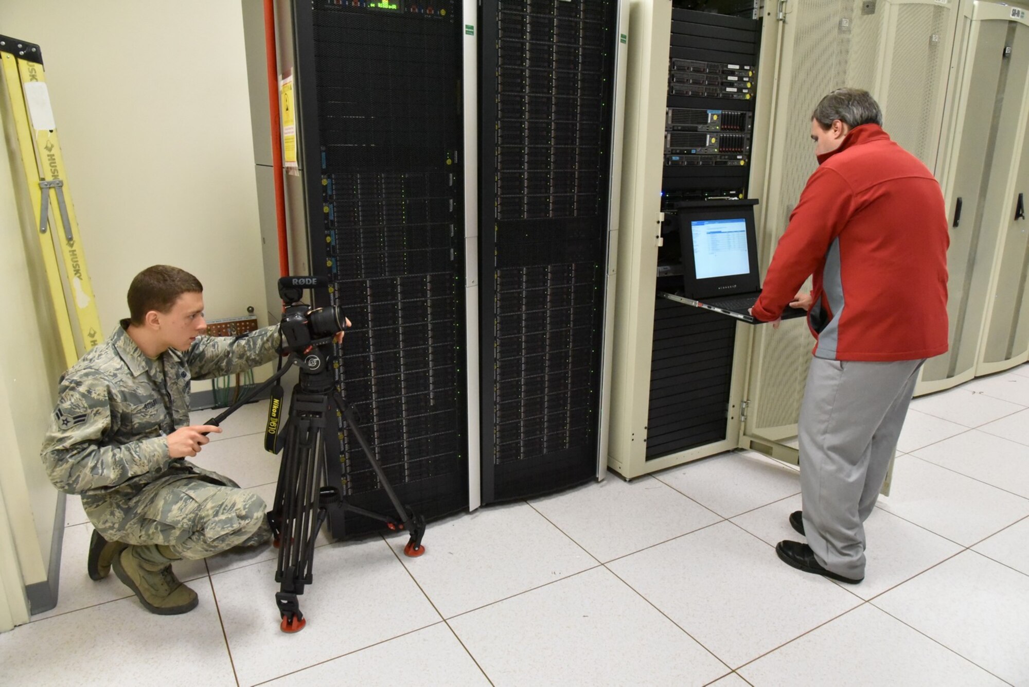 Airman 1st Class Gabriel Stuart, from Barksdale Air Force Base, Louisiana, shoots video of a Kirtland employee at work. The videographers spent two weeks at Kirtland getting footage for a wing mission video. (Photo by Ken Moore)
