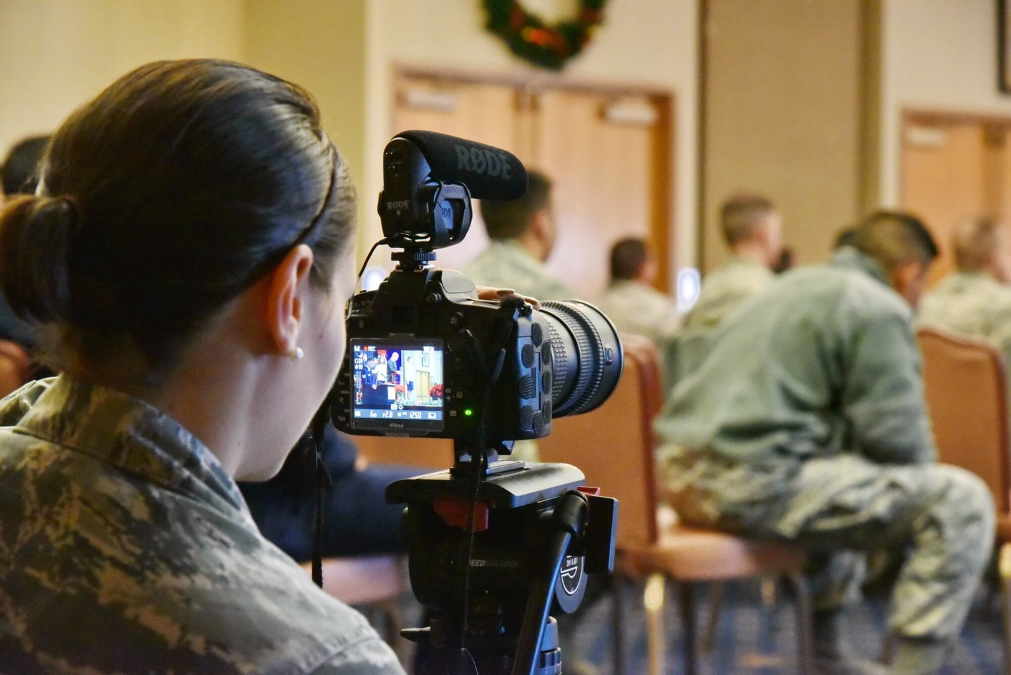 Senior Airman Shellby Matullo, from Barksdale Air Force Base, Louisiana, shoots video at a Kirtland promotion ceremony. The videographers spent two weeks at Kirtland getting footage for a wing mission video. (Photo by Ken Moore)