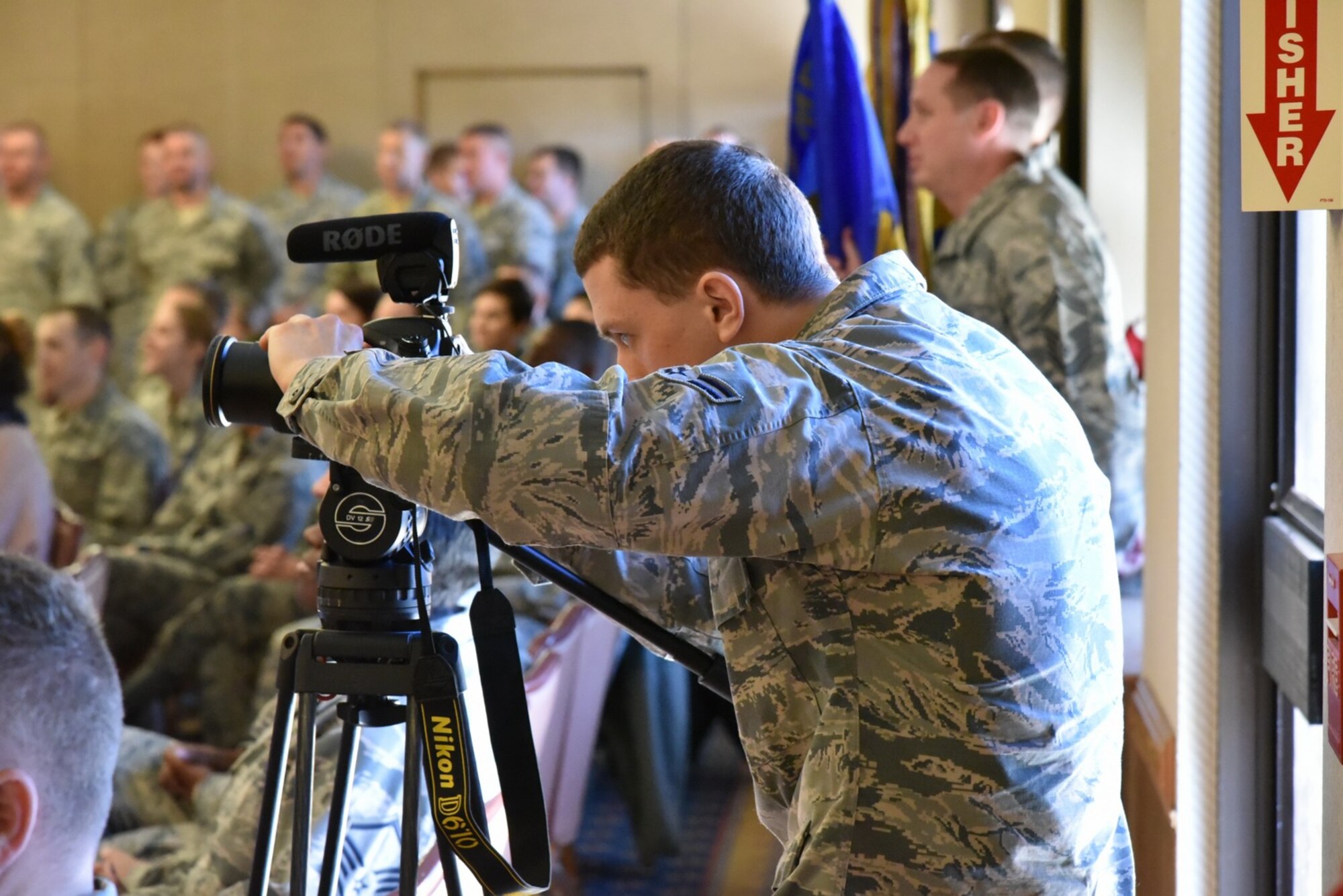 Airman 1st Class Gabriel Stuart, from Barksdale Air Force Base, Louisiana, shoots video at a Kirtland promotion ceremony. The videographers spent two weeks at Kirtland getting footage for a wing mission video. (Photo by Ken Moore)