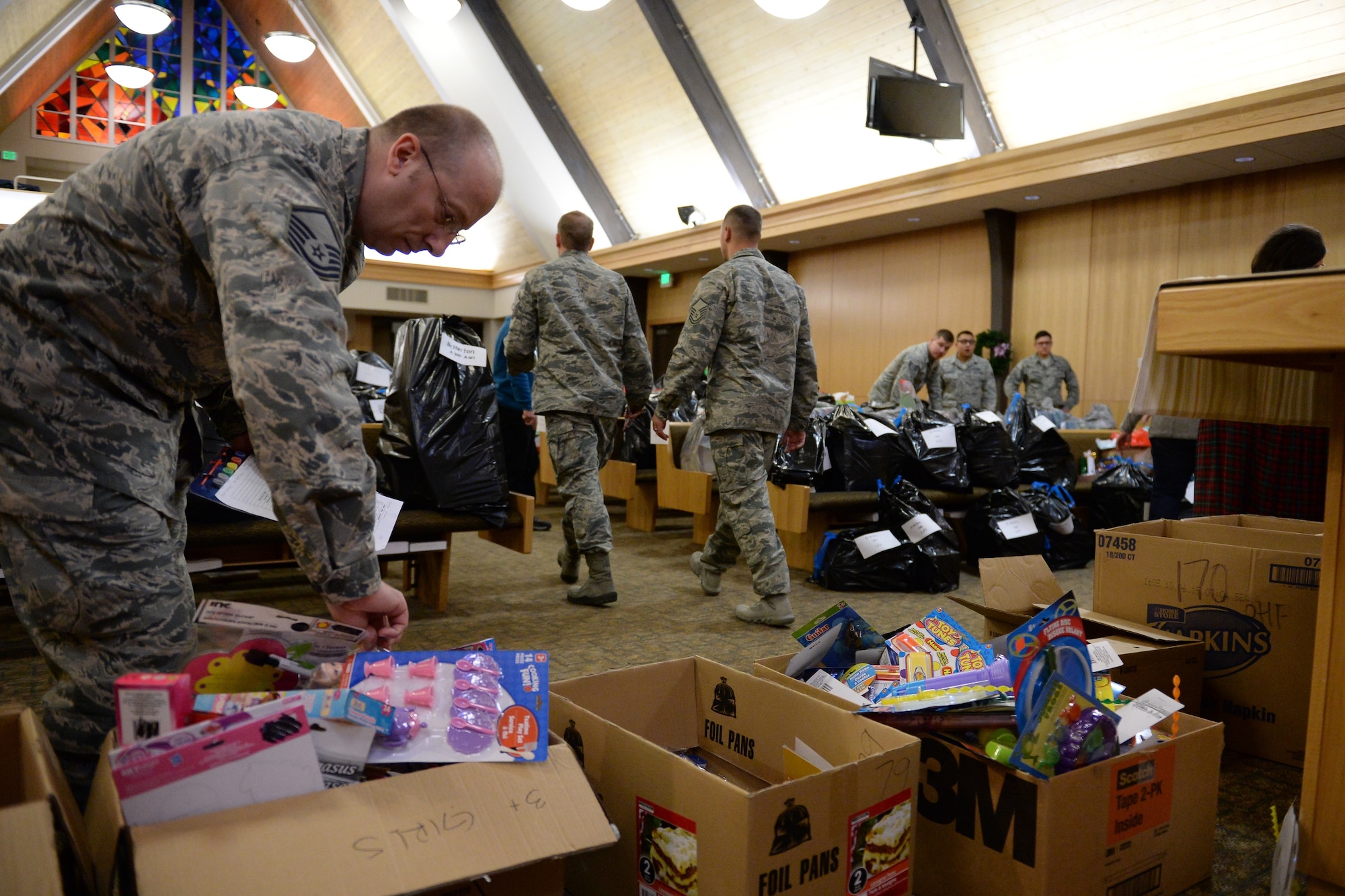 Team Hill Airmen sort and package Angel Tree gifts Dec. 9 in the chapel at Hill Air Force Base. This year’s Angel Tree program provided gifts to 300 children of military families. (U.S. Air Force photo by R. Nial Bradshaw)