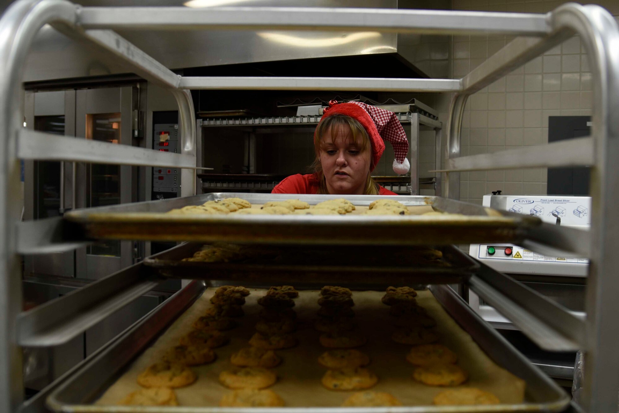 Jessica McCollum, Cookie Caper committee member, shelves baking sheets at Misawa Air Base, Japan, Dec. 7, 2015. McCollum and other volunteers baked more than 300 dozen cookies from 8 a.m. to 4 p.m. (U.S. Air Force photo by Airman 1st Class Jordyn Fetter/Released)