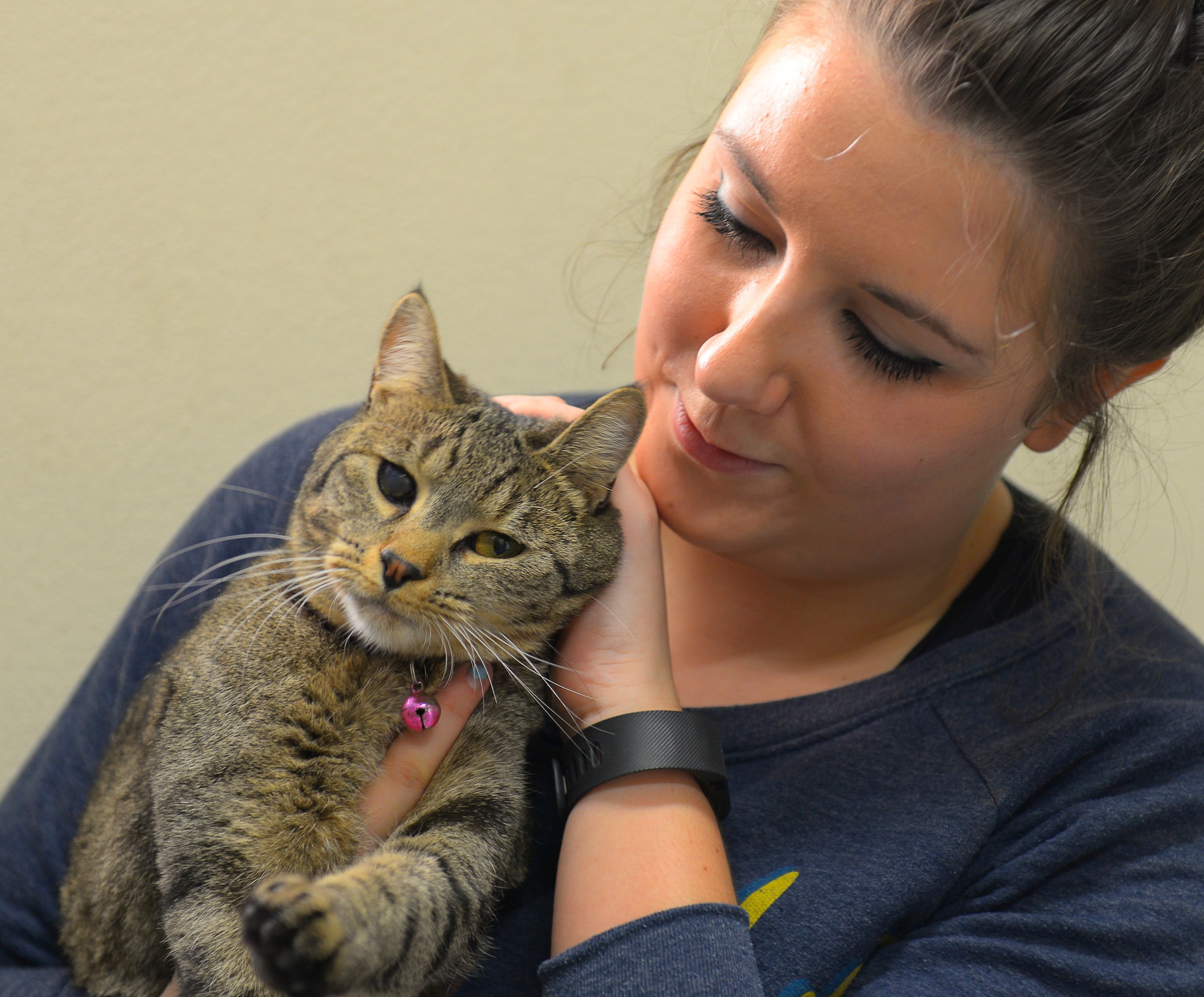 Trisha Gouldner, Yokota Pet Care Center animal care provider, tends to a customer’s cat at Yokota Air Base, Japan, Dec. 9, 2015. Gouldner said she tries to give a lot of love and attention to the animals boarded at the center. (U.S. Air Force photo by Airman 1st Class Elizabeth Baker/Released)