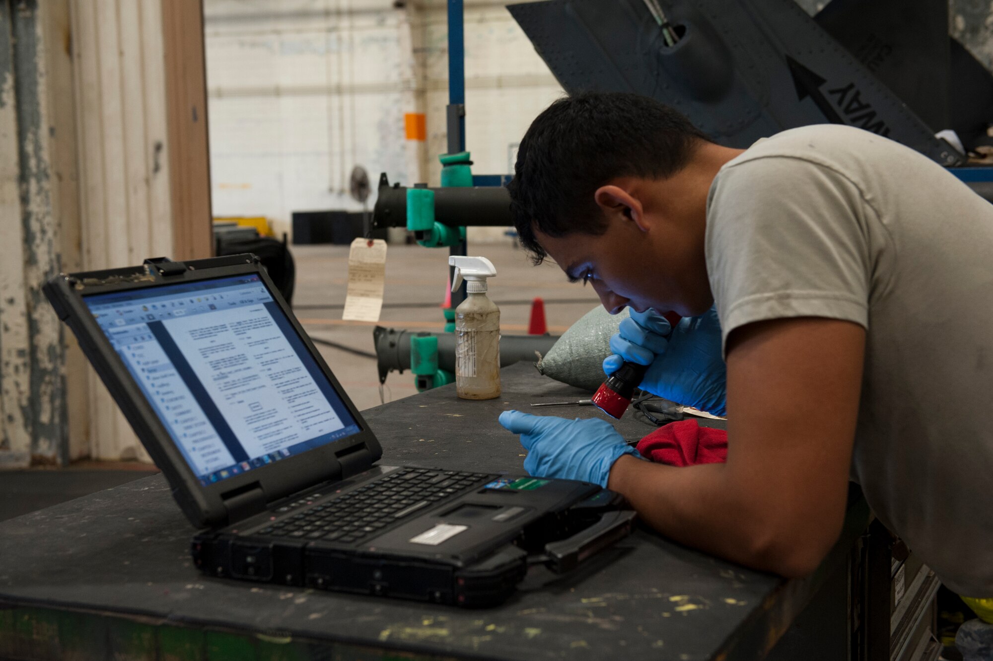 U.S. Air Force Senior Airman Jefersson Casella, 33rd Helicopter Maintenance Unit crew chief, uses his technical orders to inspect a drive shaft flange during the phase inspection for one of their HH-60G Pave Hawk helicopters Dec. 10, 2015, at Kadena Air Base, Japan. The phase inspection takes place for all helicopters once they reach 600 flight hours and ensures the continued safe and reliable operation of the aircraft. (U.S. Air Force photo by Airman Zackary A. Henry)