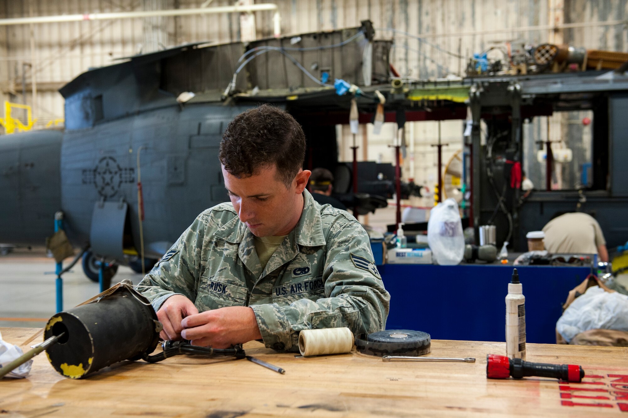 U.S. Air Force Senior Airman Griffin Rusk, 33rd Helicopter Maintenance Unit flight control specialist, removes a stabilator transmitter for the depot field team during a phase inspection Dec. 10, 2015, at Kadena Air Base, Japan. Rusk is assisting the depot field team responsible for any and all maintenance that the 33rd HMU can not fix in-house. (U.S. Air Force photo by Airman Zackary A. Henry)