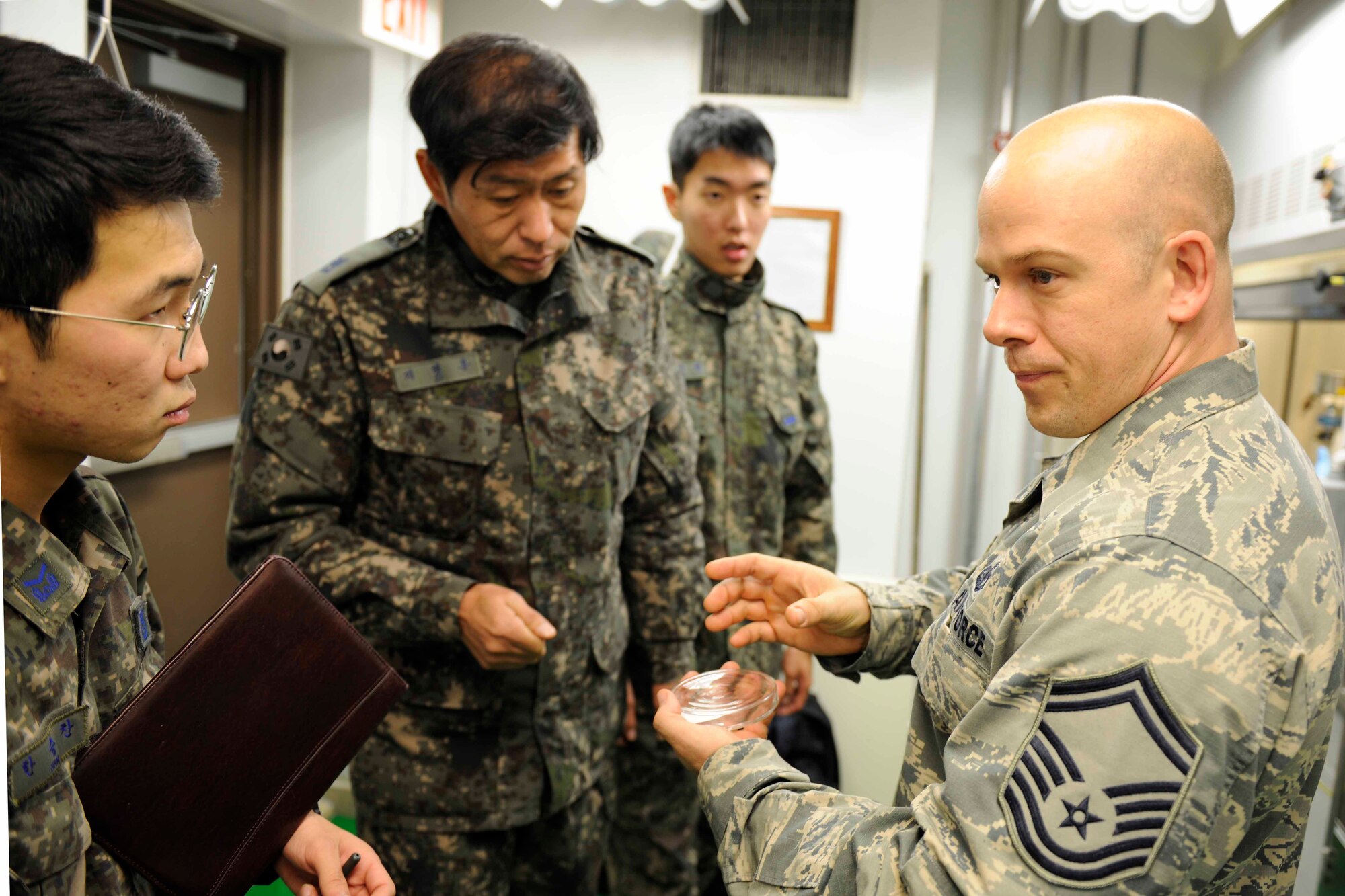Senior Master Sgt. Johnathon Northington explains some of the ways they look for impurities in the fuel to Republic of Korea Air Force Petroleum Oil and Lubricants Airmen at Kunsan Air Base, Republic of Korea on Dec. 8. This training is scheduled to take place every quarter to build partnership capacity with ROKAF counterparts.