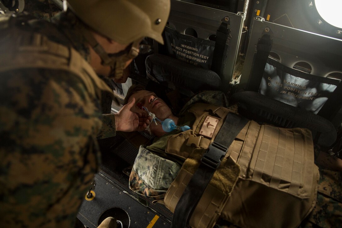 A hospital corpsman assess a simulated patient during a casualty evacuation drill on Marine Corps Air Station Futenma, Dec. 8, 2015. The casevac course is two weeks long and gives the students a better understanding of what it means to be a corpsman. The corpsmen are with various units with III Marine Expeditionary Force. (U.S. Marine Corps photo by Cpl. Ryan C. Mains/ Released)