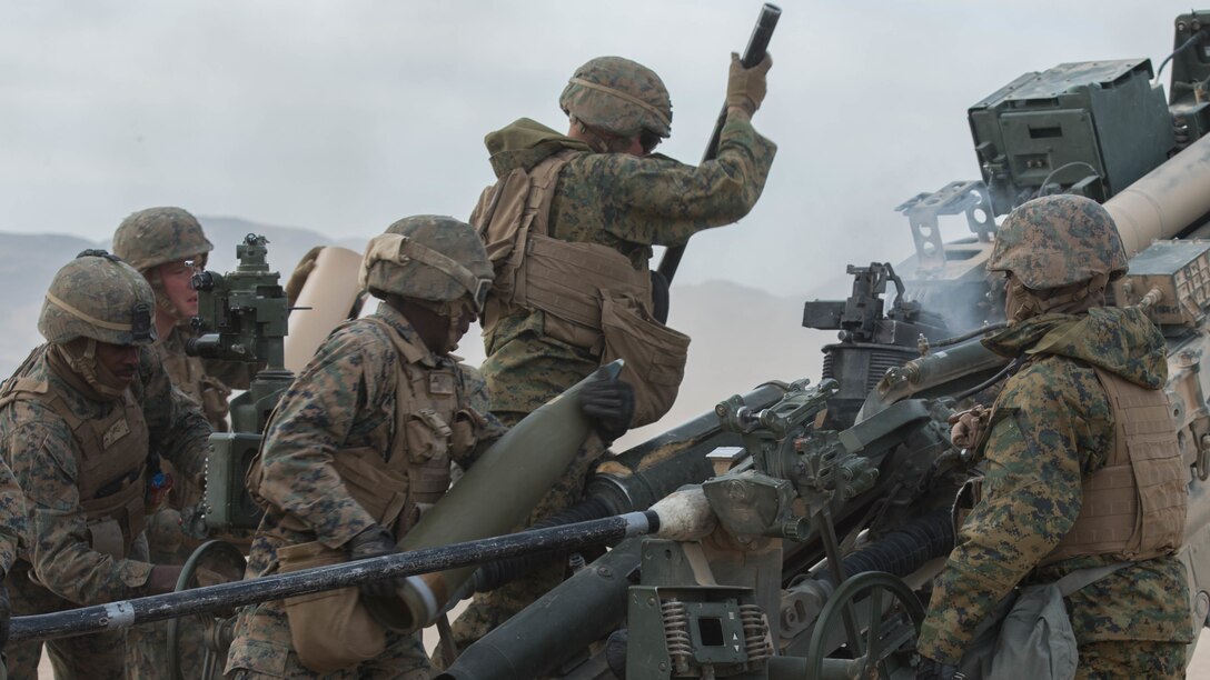 Marines with Battery I, 3rd Battalion, 11th Marine Regiment, 1st Marine Division, fire an M777 Howitzer¬ during the opening day of live-fire operations for Steel Knight at Marine Corps Air Ground Combat Center Twentynine Palms, California, on Dec. 10, 2015. The tough, realistic training is intended to develop combat skills necessary to operate as the ground combat element of the I Marine Expeditionary Force.