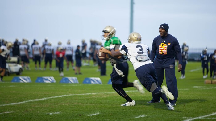 Lt. Col. Robert B. Green runs football players through drills during practice Nov. 17, 2015, at the U.S. Naval Academy in Annapolis, Maryland. Green recently was appointed the outside linebacker coach of the team. Green is a Naval Academy graduate, and played on the football team as a defensive back during the 1993-1996 seasons.