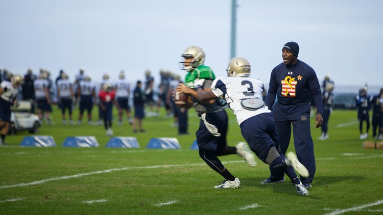 Lt. Col. Robert B. Green runs football players through drills during practice Nov. 17, 2015, at the U.S. Naval Academy in Annapolis, Maryland. Green recently was appointed the outside linebacker coach of the team. Green is a Naval Academy graduate, and played on the football team as a defensive back during the 1993-1996 seasons.