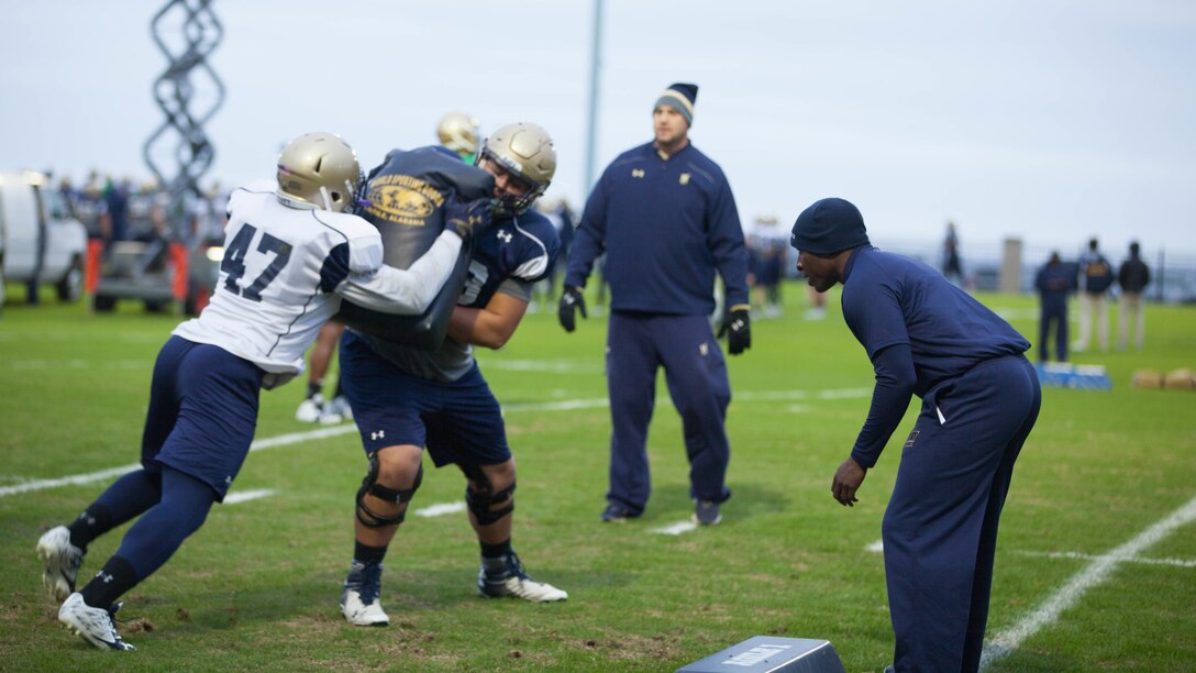 Lt. Col. Robert B. Green runs football players through drills during practice Nov. 17, 2015, at the U.S. Naval Academy in Annapolis, Maryland. Green recently was appointed the outside linebacker coach of the team. Green is a Naval Academy graduate, and played on the football team as a defensive back during the 1993-1996 seasons.