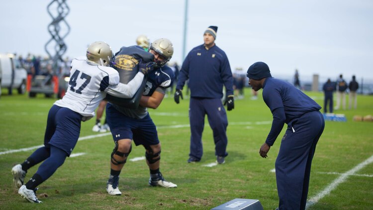 Lt. Col. Robert B. Green runs football players through drills during practice Nov. 17, 2015, at the U.S. Naval Academy in Annapolis, Maryland. Green recently was appointed the outside linebacker coach of the team. Green is a Naval Academy graduate, and played on the football team as a defensive back during the 1993-1996 seasons.