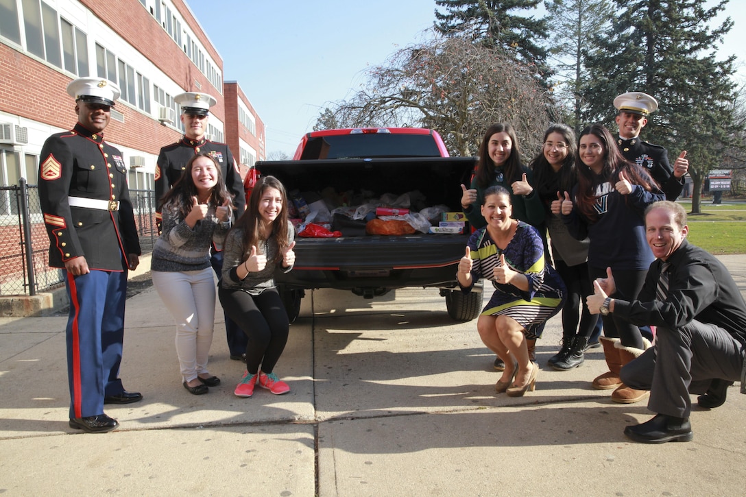 Marines from the 1st Marine Corps District pose for a photo with students and staff during a “Toys for Tots” pick up at H. Frank Carey High School, Dec. 10 at Franklin Square, N.Y. “Toys for Tots” has been around for such a long time and they have done such a great job every year,” said Clarice Tenorio, a senior at H. Frank Carey High School.