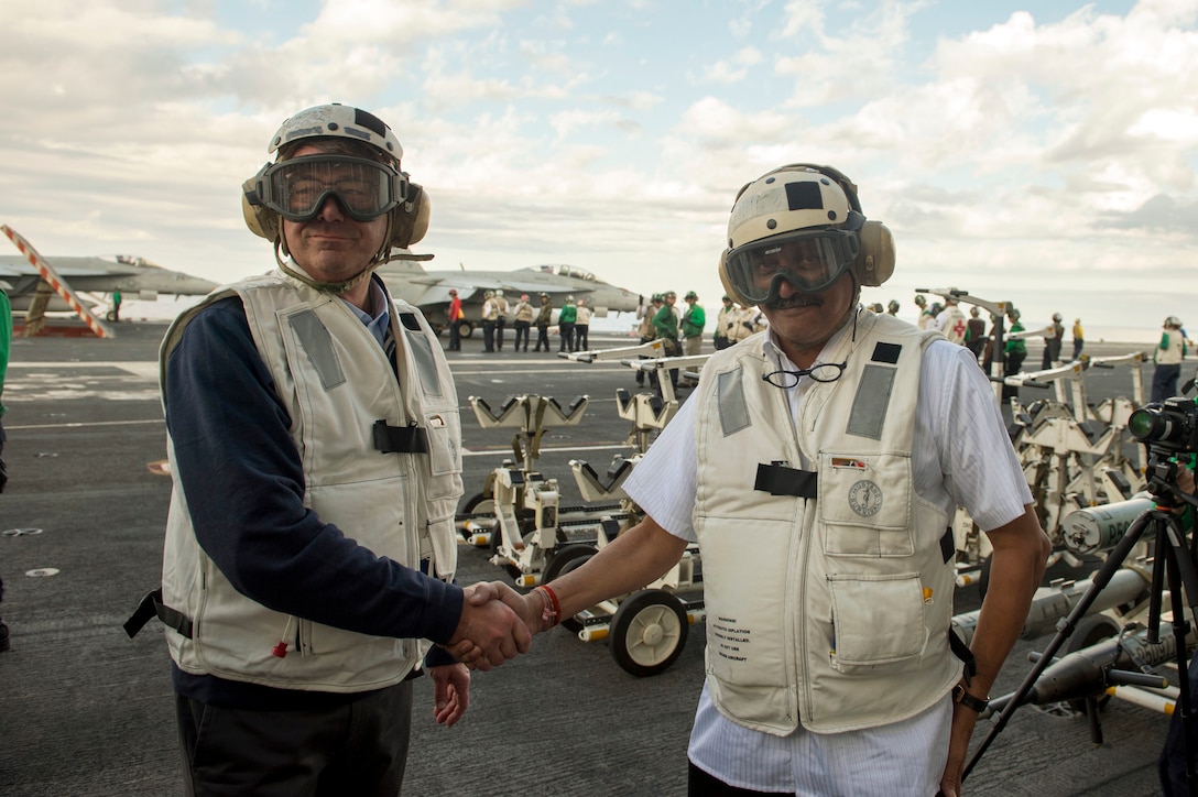 U.S. Defense Secretary Ash Carter, left, shakes hands with Indian Defense Minister Manohar Parrikar as they tour the USS Dwight D. Eisenhower in the Atlantic Ocean, Dec. 10, 2015. DoD photo by Air Force Senior Master Sgt. Adrian Cadiz 