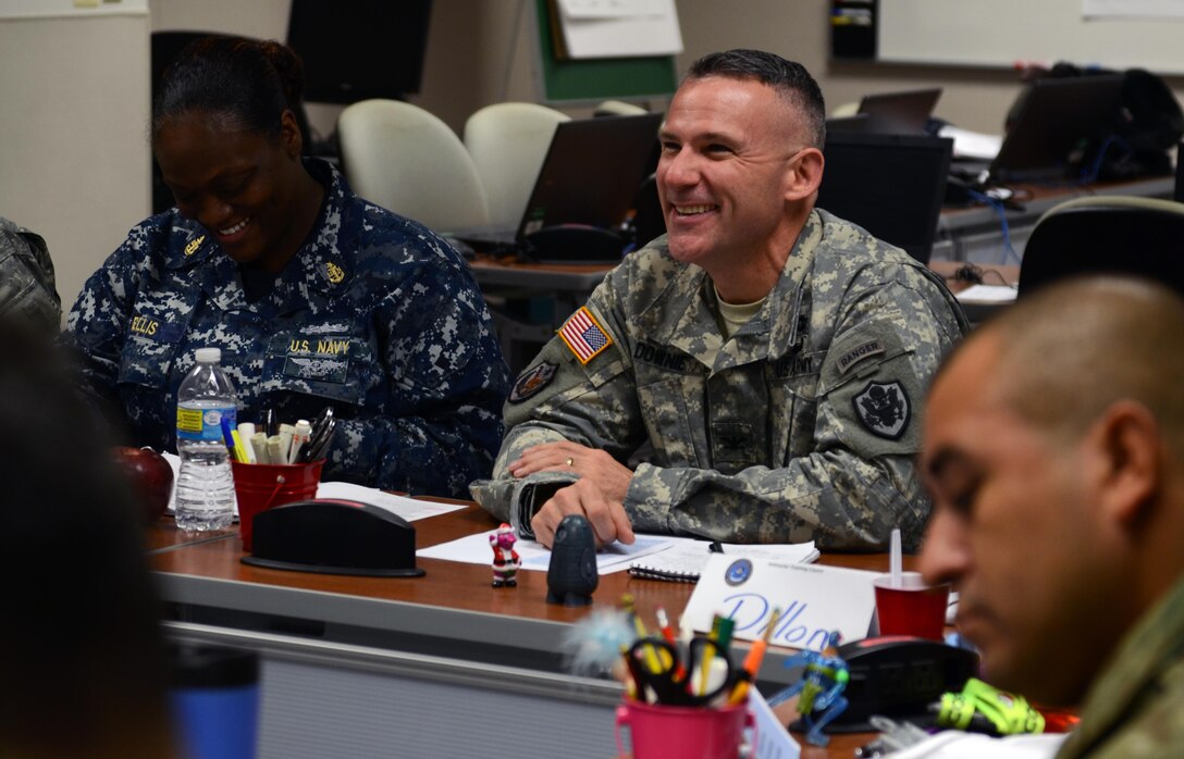 Army Col. Martin Downie, the commandant of the Defense Information School at Fort Meade, Md., reacts to a comment Nov. 9 during an Instructor Training Course class at the school. Downie, who assumed his responsibilities in June, sits in regularly on classes as part of his commitment to communicating with members of the faculty, staff and student body.