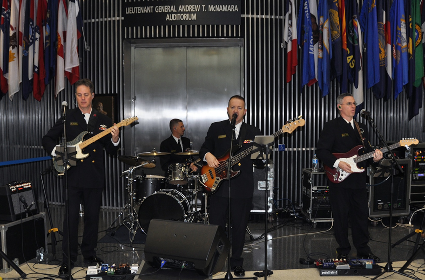 The U.S. Naval Academy Electric Brigade band entertains McNamara Headquarters Complex employees during the holiday social Dec. 9. 