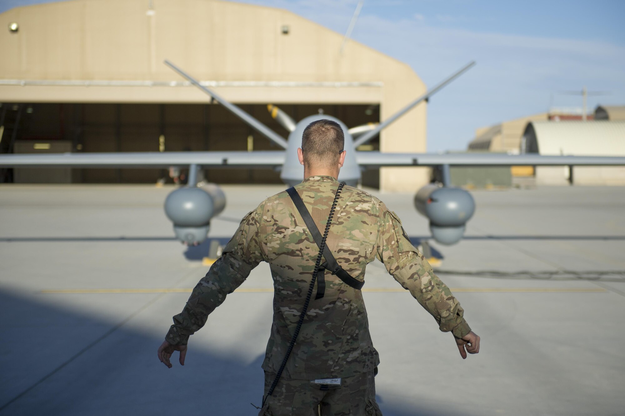 Airman 1st Class Landon, 62nd Expeditionary Reconnaissance Squadron aircraft specialist, performs preflight checks on an MQ-9 Reaper equipped with Gorgon Stare prior to a sortie at Kandahar Airfield, Afghanistan, Dec. 5, 2015. Gorgon Stare provides day or night continuous broad-area motion imagery to find and fix targets within the field of view. (U.S. Air Force photo by Tech. Sgt. Robert Cloys/Released)