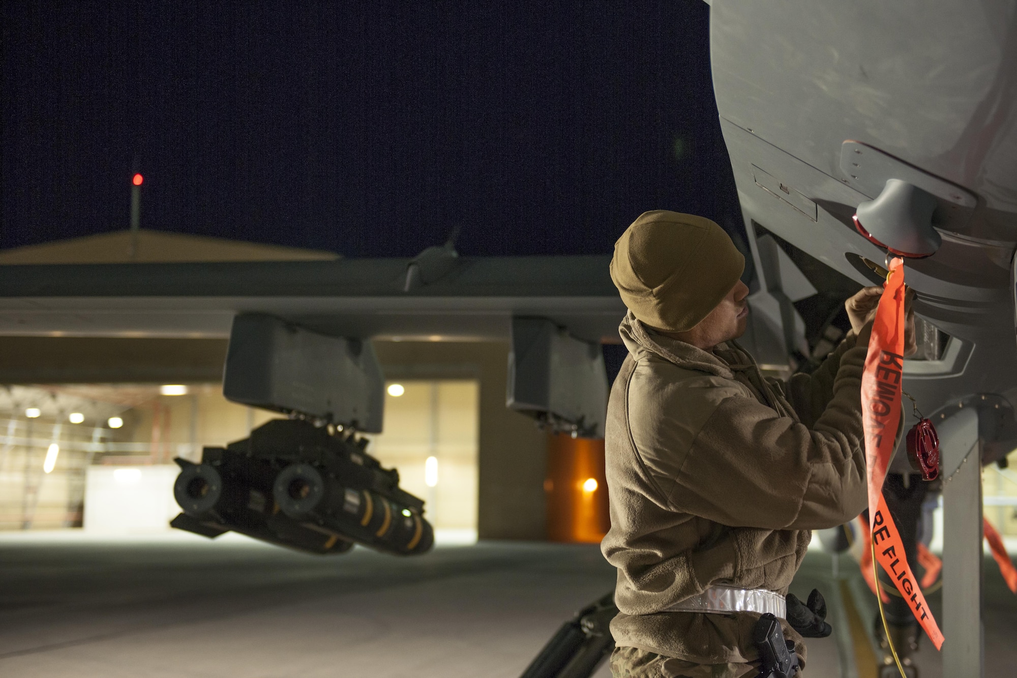 Master Sgt. George, 62nd Expeditionary Reconnaissance Squadron production superintendent, replaces a cap on an MQ-9 Reaper at Kandahar Airfield, Afghanistan, Dec. 6, 2015. The Reaper is an armed, multi-mission, medium-altitude, long-endurance remotely piloted aircraft that is employed primarily as an intelligence-collection asset and secondarily against dynamic execution targets. (U.S. Air Force photo by Tech. Sgt. Robert Cloys/Released)