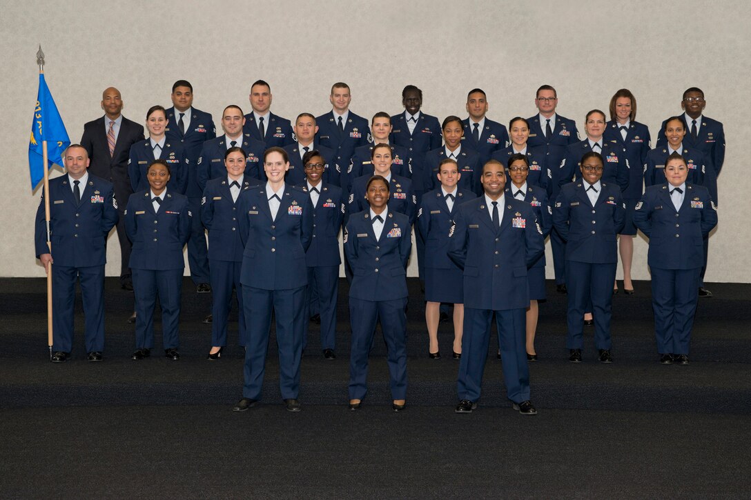 Members of the 913th Force Support Squadron pose for a squadron photo before an assumption of command ceremony at Little Rock Air Force Base, Ark., Dec. 6, 2015. The squadron was inspected in service dress blue uniforms immediately after the photo was taken, and prior to Lt. Col. Rosalind L. Abdulkhalik assuming command of the 913th FSS. (U.S. Air Force photo by Master Sgt. Jeff Walston/Released) 