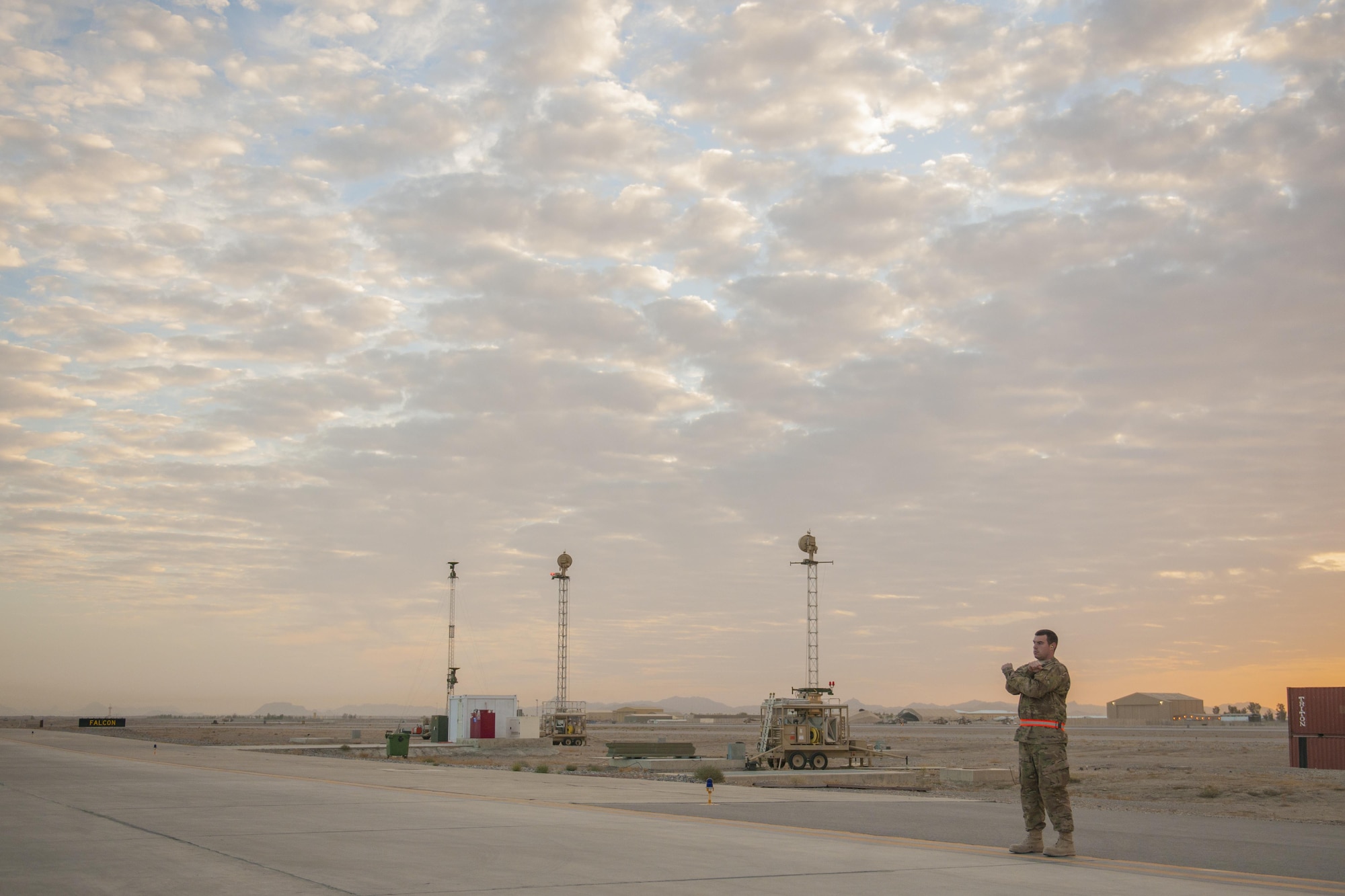 Senior Airman Christopher, 62nd Expeditionary Reconnaissance Squadron weapons load crew member, marshals an MQ-9 Reaper for end-of-runway checks at Kandahar Airfield, Afghanistan, Dec. 6, 2015. The Reaper is an armed, multi-mission, medium-altitude, long-endurance remotely piloted aircraft that is employed primarily as an intelligence-collection asset and secondarily against dynamic execution targets. (U.S. Air Force photo by Tech. Sgt. Robert Cloys/Released)