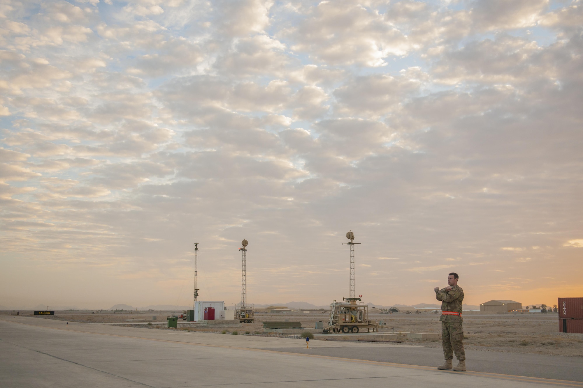 Senior Airman Christopher, 62nd Expeditionary Reconnaissance Squadron weapons load crew member, marshals an MQ-9 Reaper for end-of-runway checks at Kandahar Airfield, Afghanistan, Dec. 6, 2015. The Reaper is an armed, multi-mission, medium-altitude, long-endurance remotely piloted aircraft that is employed primarily as an intelligence-collection asset and secondarily against dynamic execution targets. (U.S. Air Force photo by Tech. Sgt. Robert Cloys/Released)